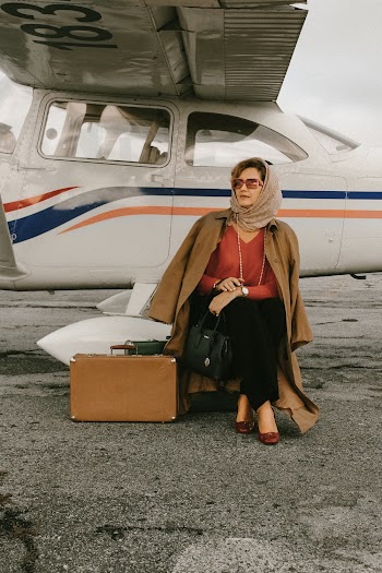 Photo of Woman Sitting Near Airplane