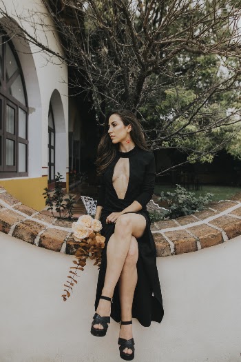Photo of Woman Sitting Near Bare Tree