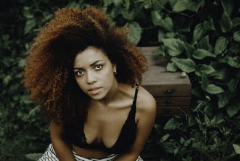 Photo Of Woman Sitting Near Bushes