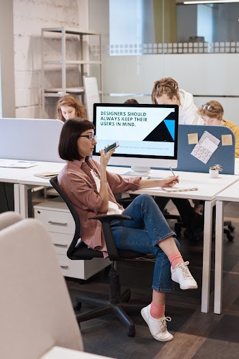 Photo Of Woman Sitting Near Computer