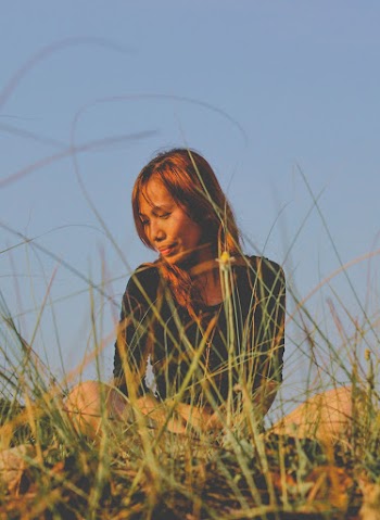 Photo of Woman Sitting Near Grass