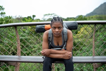 Photo Of Woman Sitting Near Handrail