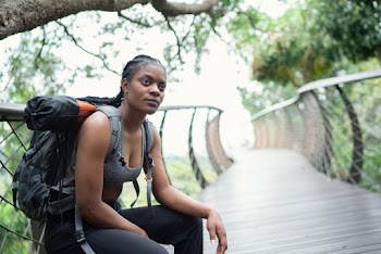 Photo Of Woman Sitting Near Handrail
