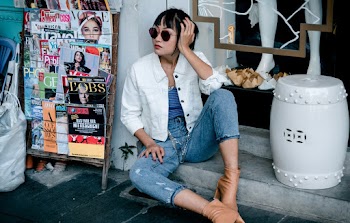 Photo Of Woman Sitting Near Magazines