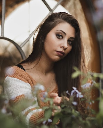 Photo Of Woman Sitting Near Plants
