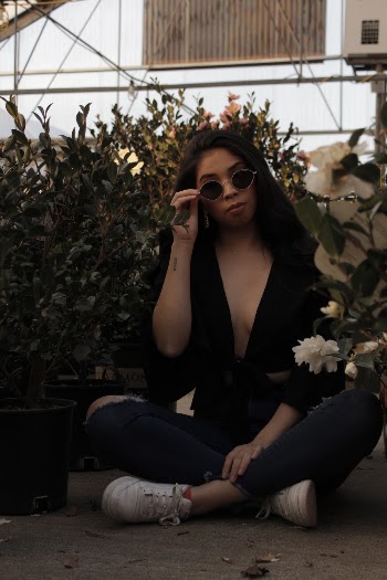 Photo Of Woman Sitting Near Plants