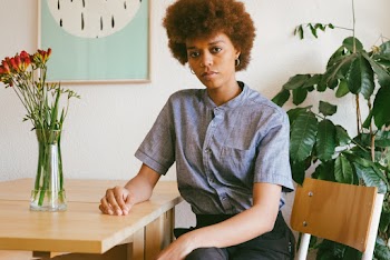 Photo Of Woman Sitting Near Plants
