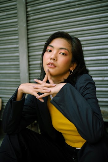 Photo of Woman Sitting Near Roller Shutter