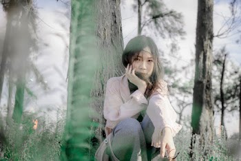 Photo of Woman Sitting Near Tree
