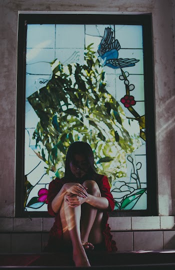 Photo Of Woman Sitting Near Window