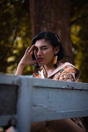 Photo Of Woman Sitting On A Bench 