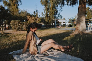 Photo of Woman Sitting on a Blanket