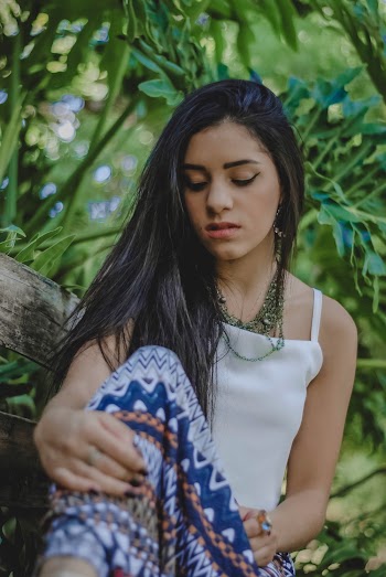 Photo of Woman Sitting on Bench