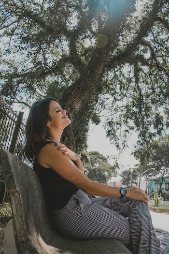 Photo of Woman Sitting on Bench Near Tree