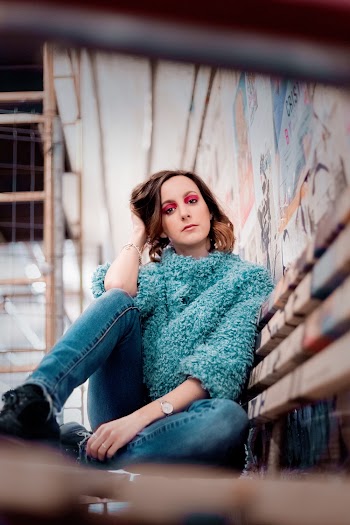 Photo of Woman Sitting on Bench Posing