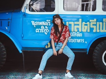Photo of Woman Sitting on Blue Truck's Side Step