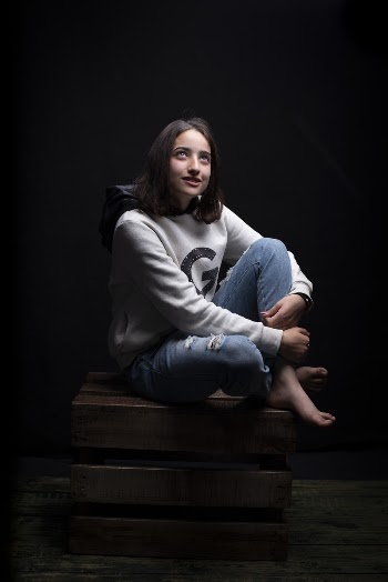 Photo of Woman Sitting on Brown Wooden Crate
