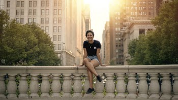 Photo Of Woman Sitting On Concrete Fence