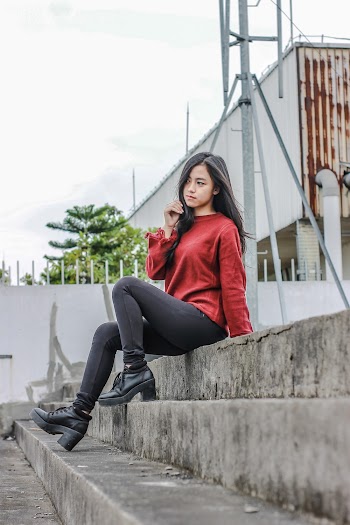 Photo of Woman Sitting on Concrete Stairs Posing
