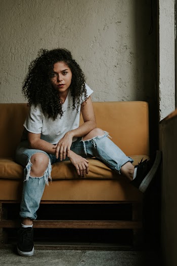 Photo of Woman Sitting on Couch