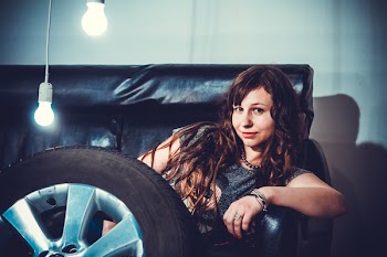 Photo of Woman Sitting on Couch Front of Wheel