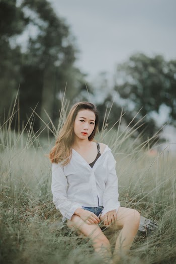 Photo Of Woman Sitting On Grass
