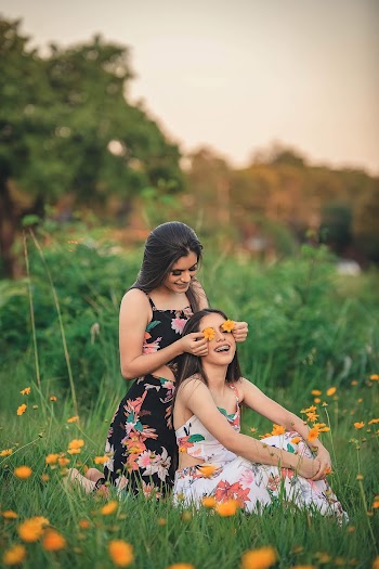 Photo Of Woman Sitting On Grass Field 