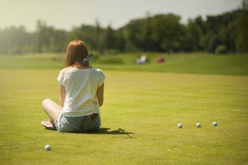 Photo of Woman Sitting on Grass Field