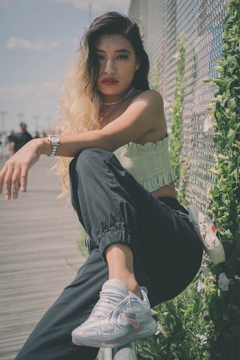 Photo Of Woman Sitting On Handrail