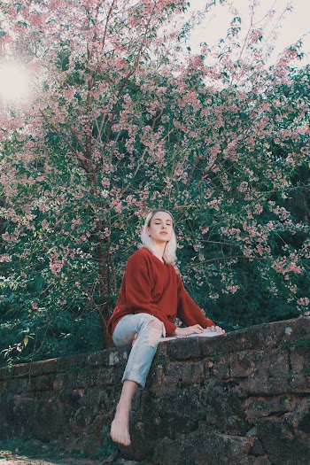 Photo of Woman Sitting On Ledge