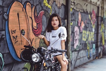 Photo of Woman Sitting on Motorcycle