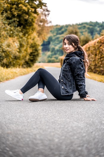 Photo of Woman Sitting on Pavement