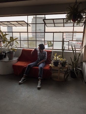 Photo Of Woman Sitting On Red Sofa 