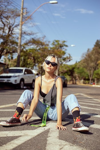 Photo Of Woman Sitting On Road