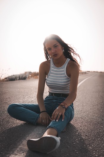 Photo Of Woman Sitting On Road Way