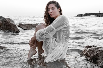 Photo of Woman Sitting On Rock