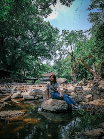 Photo of Woman Sitting on Rock