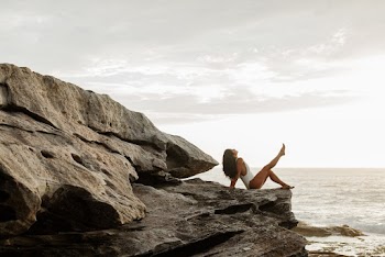 Photo Of Woman Sitting On Rock