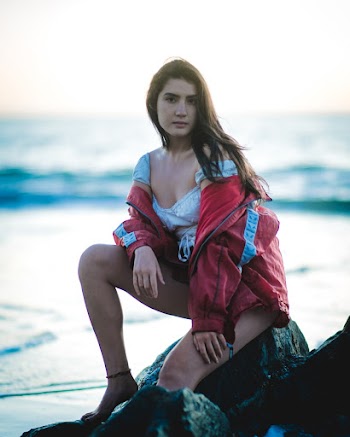 Photo Of Woman Sitting On Rock