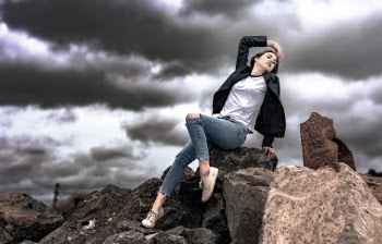 Photo of Woman Sitting on Rocks