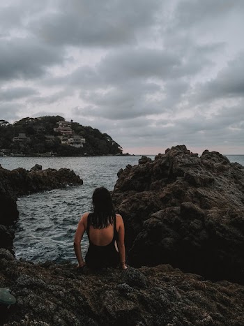 Photo of Woman Sitting on Rocks