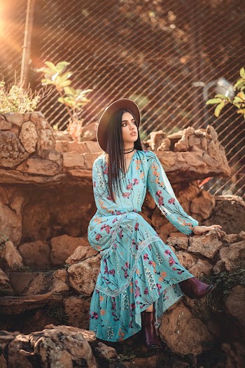Photo of Woman Sitting on Rocks