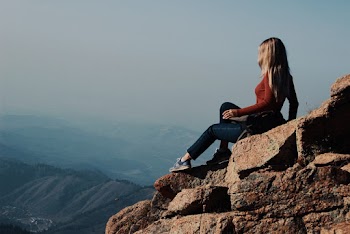Photo of Woman Sitting on Rocks