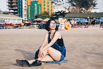 Photo of Woman Sitting on Sand