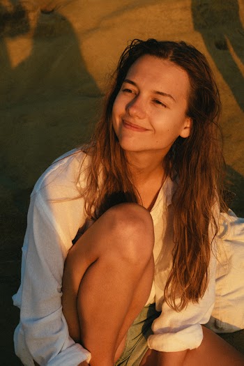 Photo Of Woman Sitting On Sand
