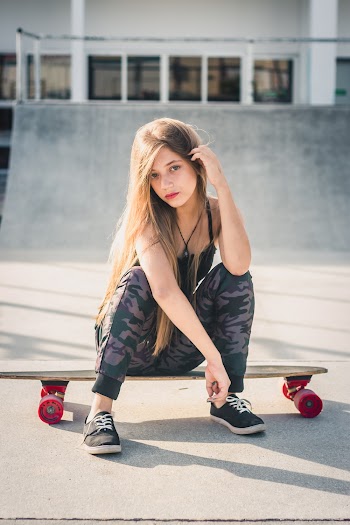Photo of Woman Sitting on Skateboard