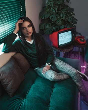 Photo of Woman Sitting on Sofa