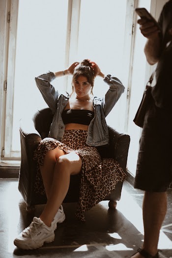 Photo Of Woman Sitting On Sofa