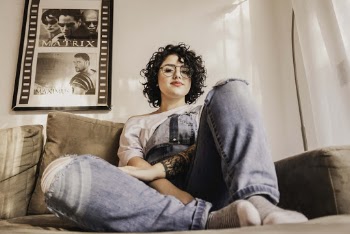 Photo Of Woman Sitting On Sofa