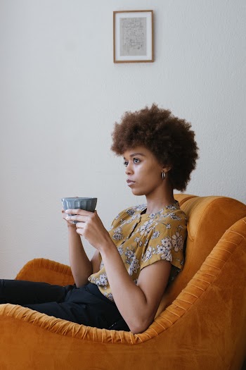 Photo Of Woman Sitting On Sofa